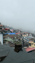 Foggy morning settles over Darjeeling's wet streets after rainfall