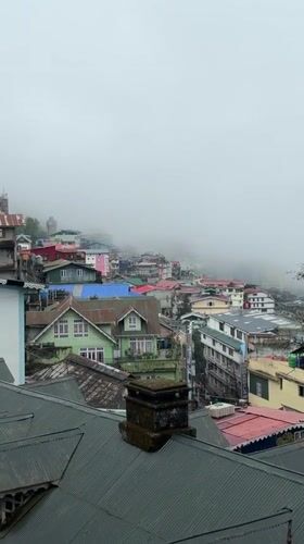 Foggy morning settles over Darjeeling's wet streets after rainfall
