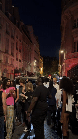 Late-night crowds fill Paris streets near a neoclassical landmark