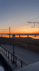 Sunset observed over water near bridge in Perm, Russia