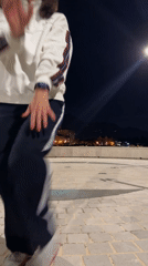 Woman dances on cobblestones in Tivat evening
