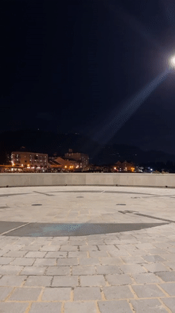 Woman dances on cobblestones in Tivat evening