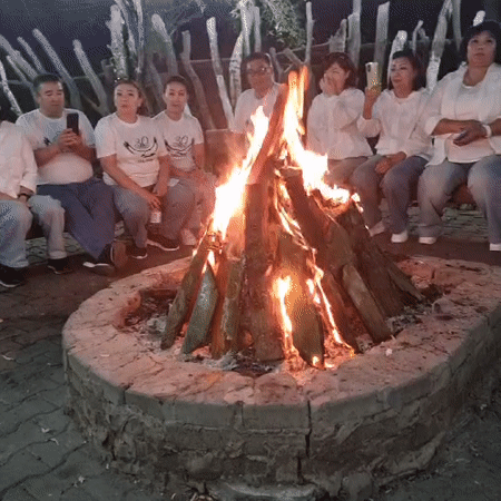 Evening party at a rustic lodge in Aktobe, indoors and out.