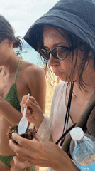 Women enjoy fresh sea urchin on General Luna beach