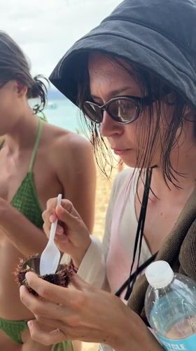 Women enjoy fresh sea urchin on General Luna beach