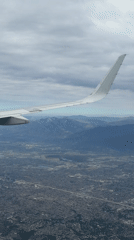 City sprawl seen from a plane window mid-flight