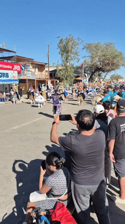Colorful street parade with costumed dancers in Pozo Almonte