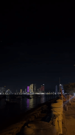 Nha Trang bay at night: boats, coastline, and neon lights