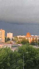 Storm clouds and a rainbow over Elektrostal, with a dog inside
