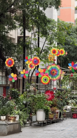 Colorful pinwheels spin in Tianhe District apartment courtyard