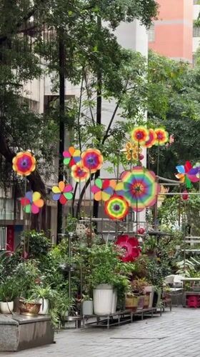 Colorful pinwheels spin in Tianhe District apartment courtyard