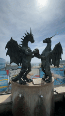 Tourist captures dragon sculpture, hotel, beachside bar in Varna