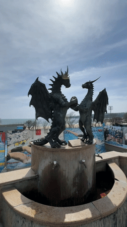 Tourist captures dragon sculpture, hotel, beachside bar in Varna