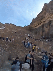 Tourists visit ancient terraced ruins in Ollantaytambo Peru