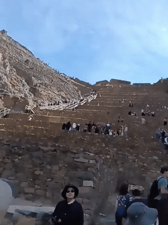 Tourists visit ancient terraced ruins in Ollantaytambo Peru