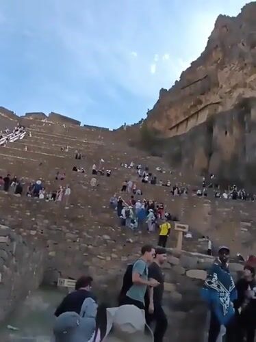 Tourists visit ancient terraced ruins in Ollantaytambo Peru