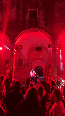 Nighttime musical performance in Venice courtyard near historic basilica