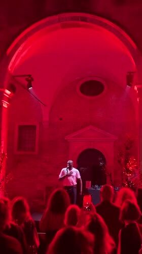 Nighttime musical performance in Venice courtyard near historic basilica