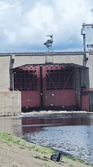 Cruise ships transit Chaikovsky dam locks while locals fish