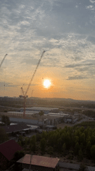Construction cranes silhouetted against sunset in Pattaya City