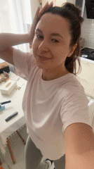 Woman exercises in kitchen during morning workout routine