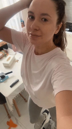 Woman exercises in kitchen during morning workout routine