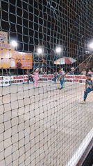 Nighttime cricket match observed in Mumbai with colorful uniforms