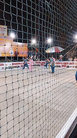 Nighttime cricket match observed in Mumbai with colorful uniforms