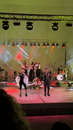 Live band performs under colorful stage lights in Shumen