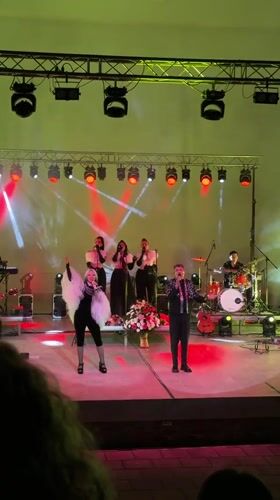 Live band performs under colorful stage lights in Shumen
