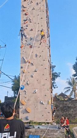 Rock climbers scale artificial wall in Blahbatuh, Indonesia