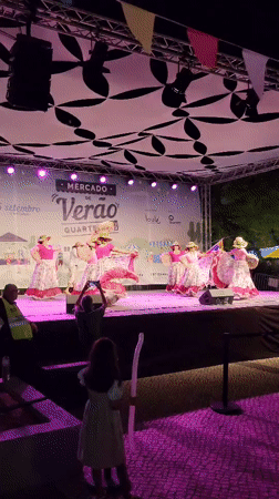 Folk dancers perform at Quarteira's summer market stage