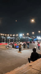 Live music and dancing at a Surakarta waterfront night gathering