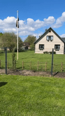 Woman with Shiba Inu enjoys sunny day in Carnikava backyard