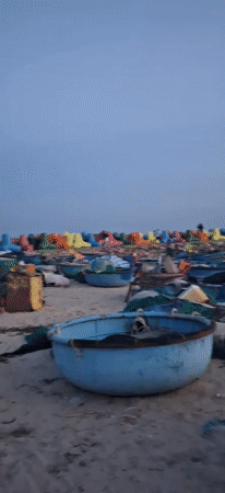 Sunset on a working beach in Phu Thuy Ward, Vietnam