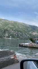 Traffic flows along Bay of Kotor waterfront in Prčanj