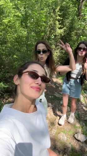 Three women take selfie on hiking trail in Montenegro