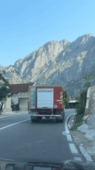 Fire truck rolls through Dobrota, Montenegro on a July morning