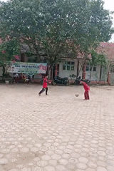 Kids play soccer in a flowering school courtyard in Indonesia