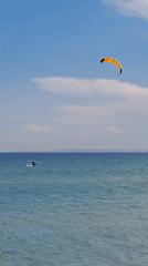 Morning beach activities under clear skies in Ukrainian coastal settlement