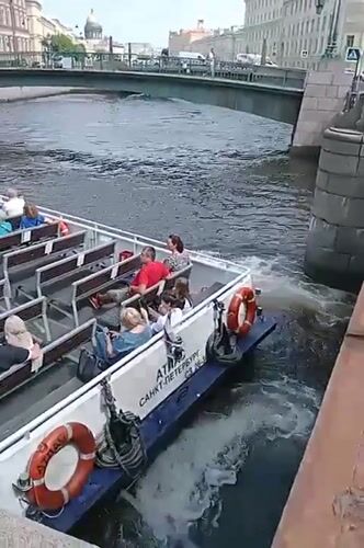Canal boats cruise Saint Petersburg's waterways near St. Isaac's Cathedral