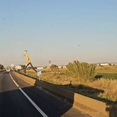 Vehicle travels highway near Bell-lloc d'Urgell under clear skies