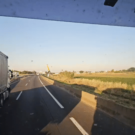 Vehicle travels highway near Bell-lloc d'Urgell under clear skies