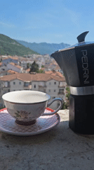 Morning outdoor dining experience with coffee, cake, and mountain views