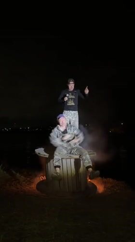 Two people in camouflage near fire and smoke, Noviy Russia
