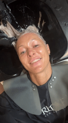 Woman enjoys hair treatment at salon Friday morning