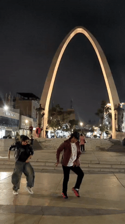 Night dancers perform in Tacna plaza, captured on video