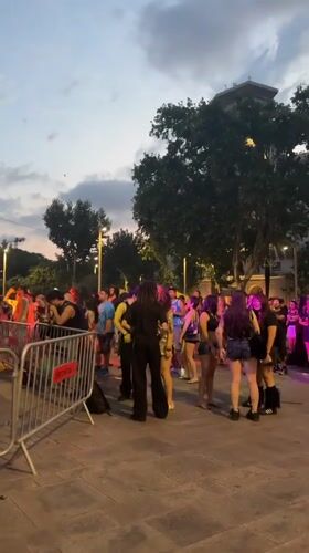 Outdoor festival crowd gathers near Barcelona's Columbus Monument at dusk