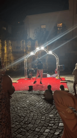 Outdoor magic show on a lit stage in Sozopol