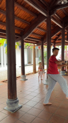 Children practice kicks, play under covered pavilion in Mũi Né